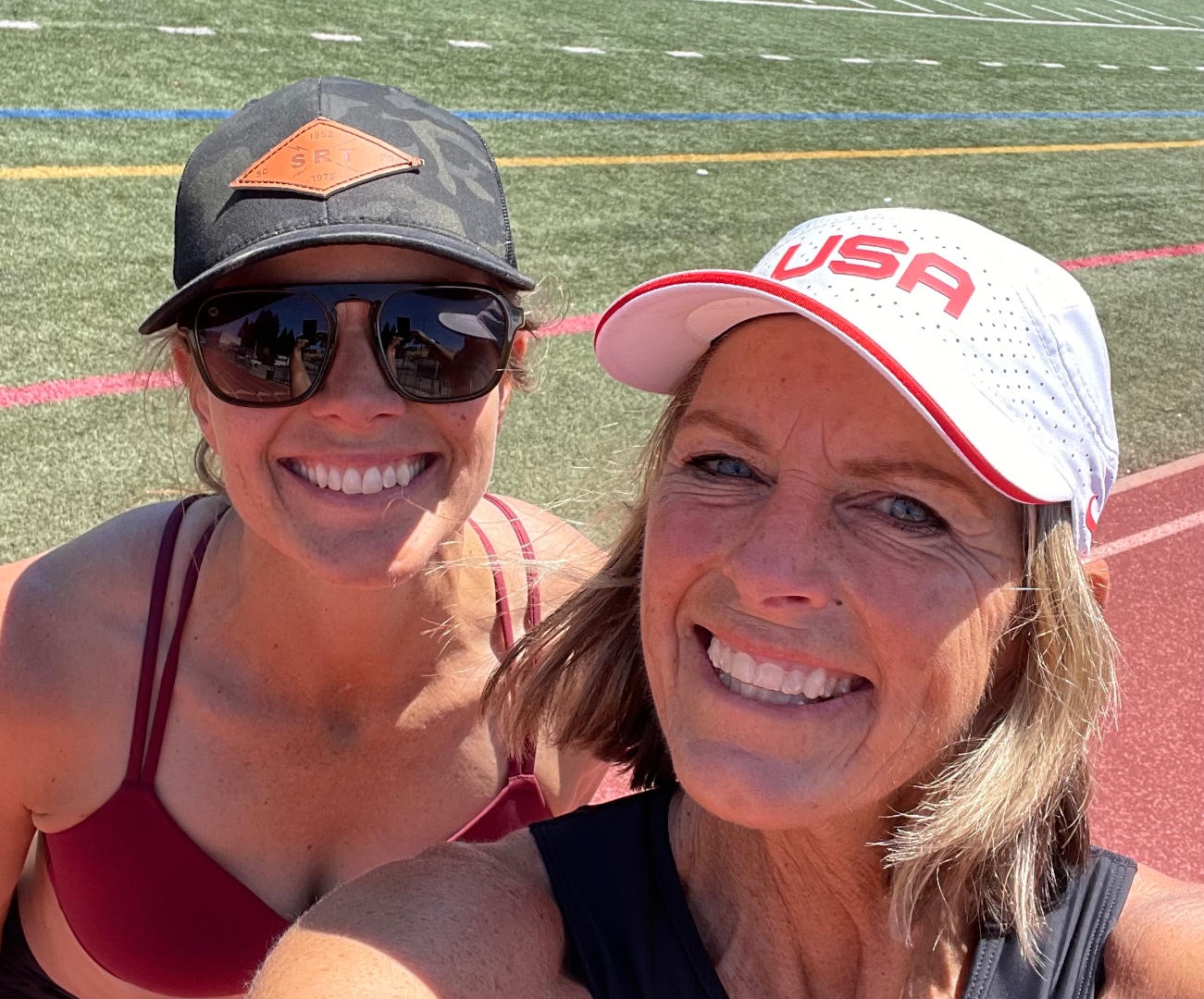 Grace Upshaw and her sister Joy Upshaw, coaches and lifelong track athletes, on a training track together.